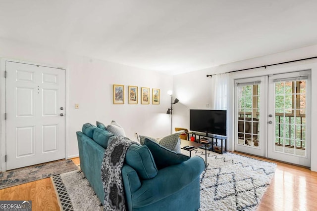 living room featuring light hardwood / wood-style flooring and french doors