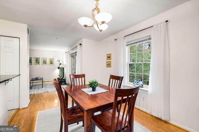 dining area featuring a chandelier and light wood-type flooring