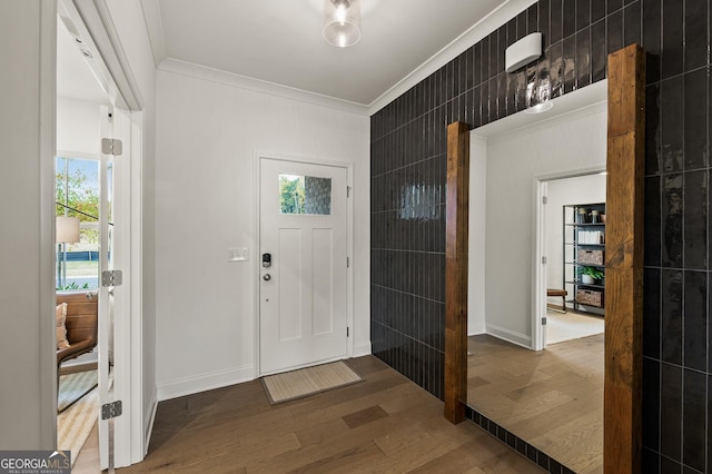 entrance foyer featuring wood-type flooring and ornamental molding