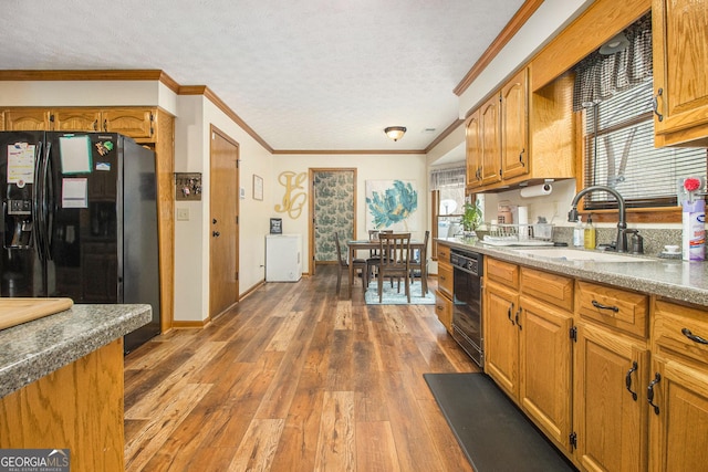 kitchen with sink, crown molding, a textured ceiling, dark hardwood / wood-style floors, and black appliances