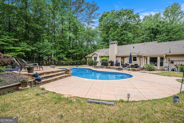 pool featuring a patio and fence
