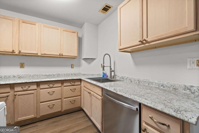 kitchen with light brown cabinetry, light stone counters, sink, dishwasher, and light hardwood / wood-style floors