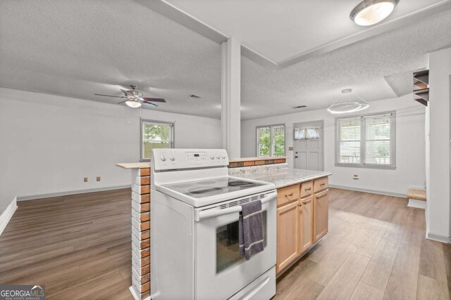 kitchen with white range with electric stovetop, a healthy amount of sunlight, light wood-type flooring, and a textured ceiling