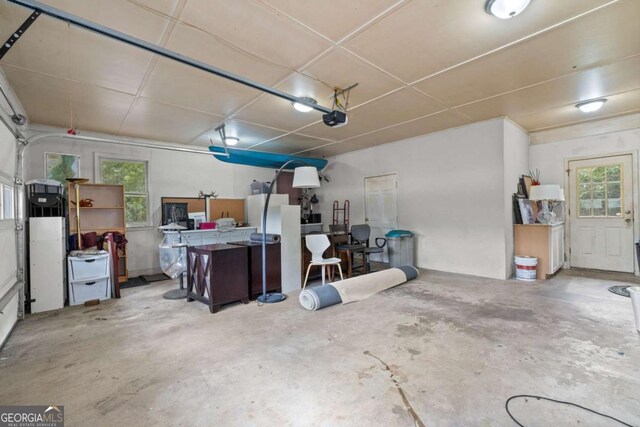 garage with white refrigerator and a garage door opener