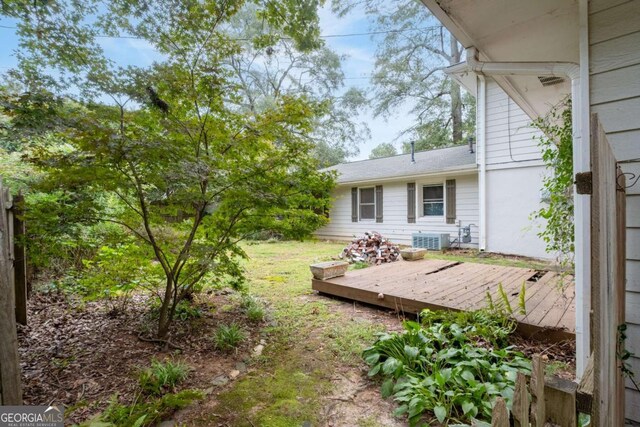 view of yard featuring cooling unit and a wooden deck