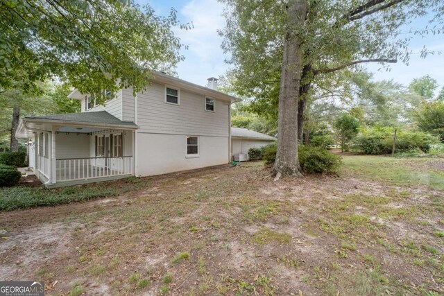 rear view of property with covered porch