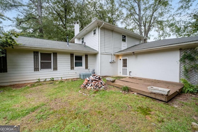 back of house with a lawn, cooling unit, and a wooden deck