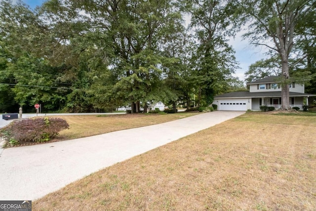 view of front of home with a front yard and a garage