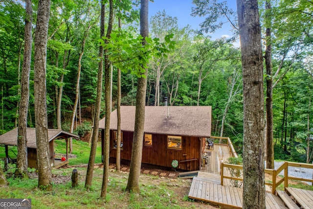 rear view of house featuring a deck