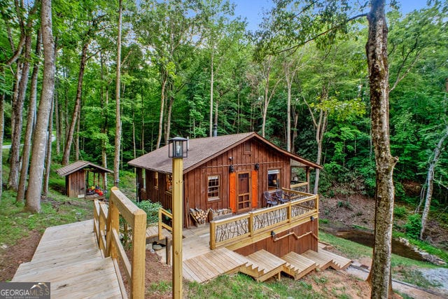 view of front facade featuring an outbuilding and a deck