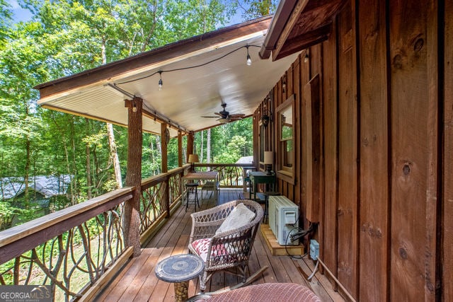 wooden terrace featuring ceiling fan