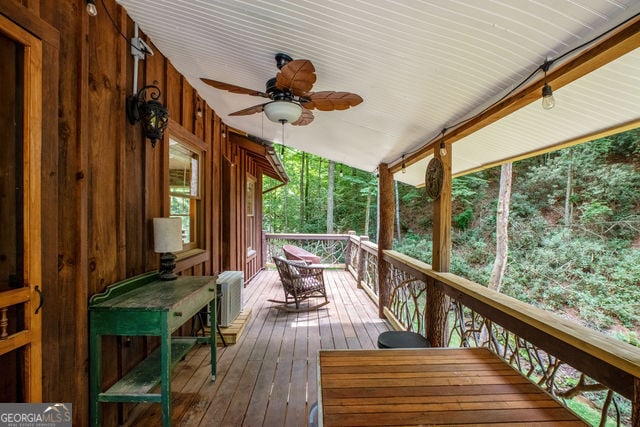 wooden deck with ceiling fan and a porch