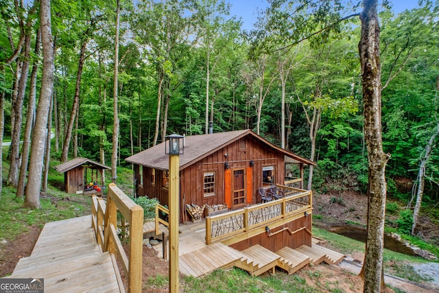 view of front of home featuring an outbuilding and a deck