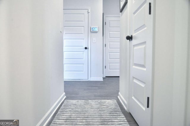 corridor featuring dark wood-type flooring