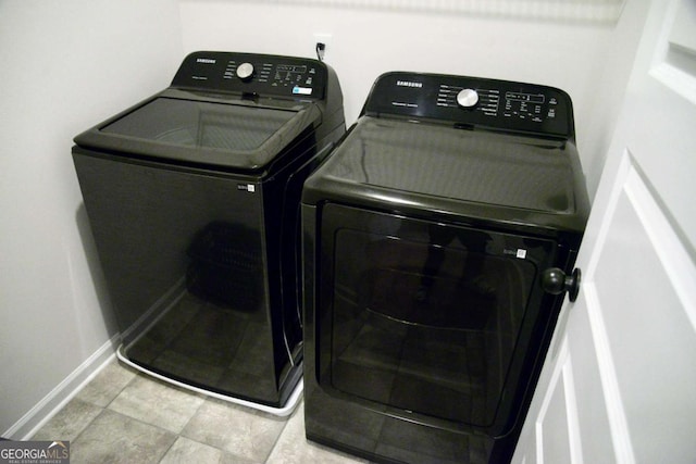 laundry room featuring washing machine and clothes dryer