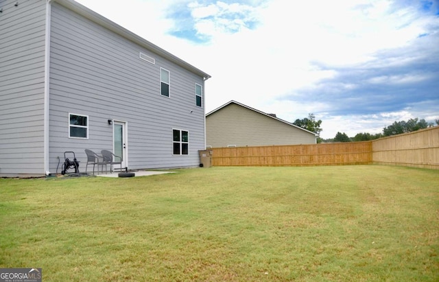 back of property featuring a yard and a patio area