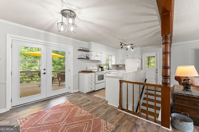 kitchen with white cabinets, plenty of natural light, white appliances, and french doors