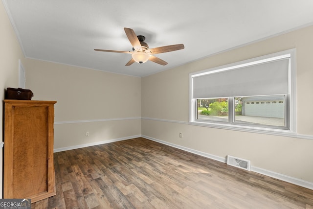 spare room featuring ceiling fan and dark hardwood / wood-style floors