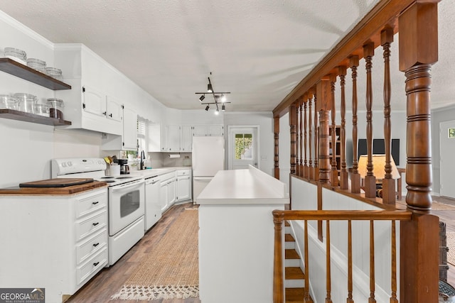 kitchen with white appliances, white cabinetry, dark wood-type flooring, and sink