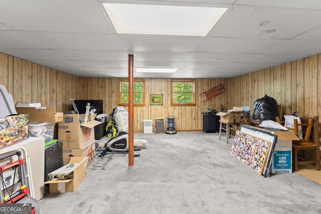 basement featuring a drop ceiling and carpet floors