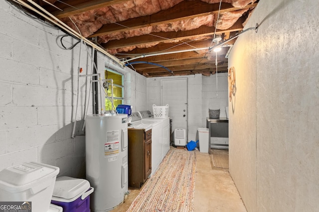 basement with electric water heater and independent washer and dryer