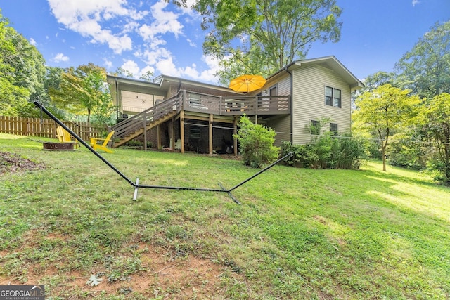 back of house with a yard and a wooden deck