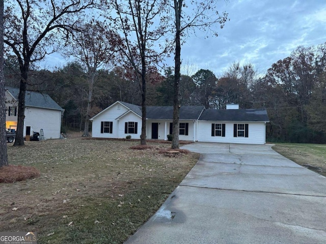 ranch-style house with a front lawn