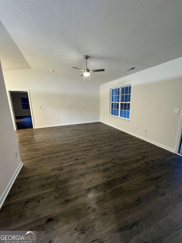 spare room featuring a textured ceiling, dark hardwood / wood-style flooring, and ceiling fan