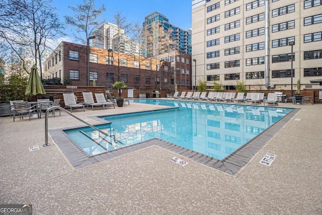 view of swimming pool with a patio