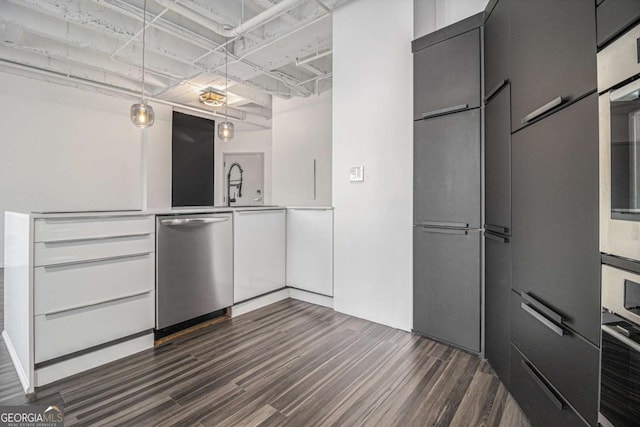 kitchen with sink, stainless steel appliances, and dark hardwood / wood-style floors