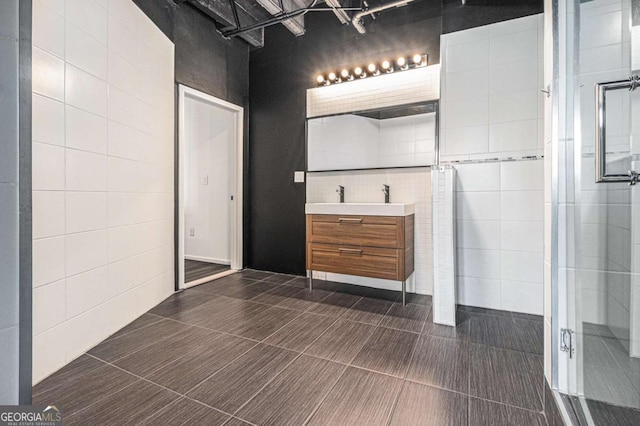 bathroom featuring vanity and a shower with door