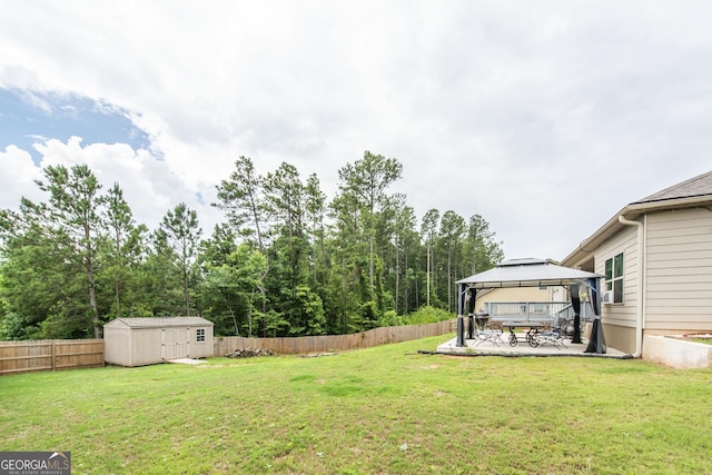 view of yard featuring a gazebo, a patio, and a storage unit