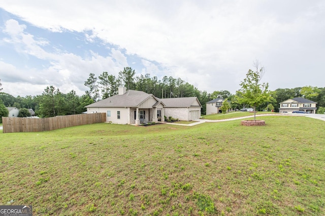 ranch-style home featuring a garage and a front yard