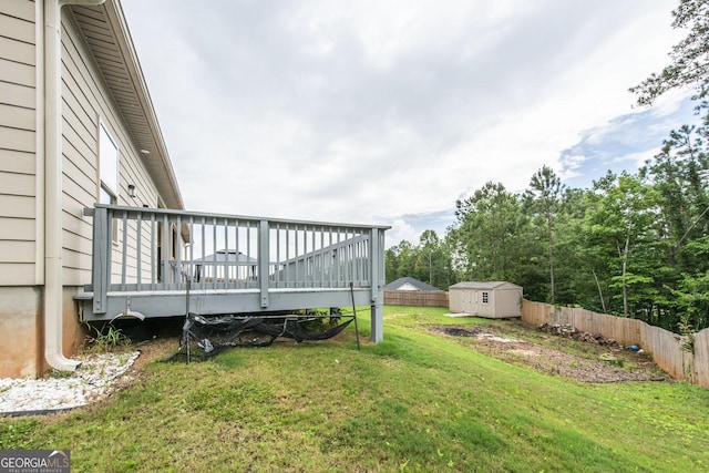 view of yard featuring a deck and a storage unit