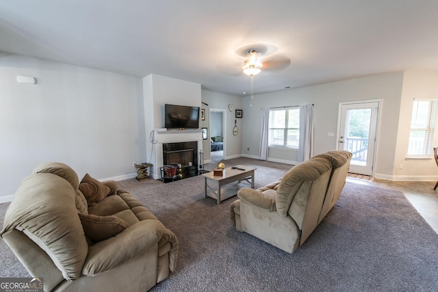 living room with ceiling fan and carpet floors