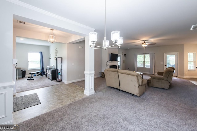 living room with light carpet, ceiling fan with notable chandelier, decorative columns, and plenty of natural light