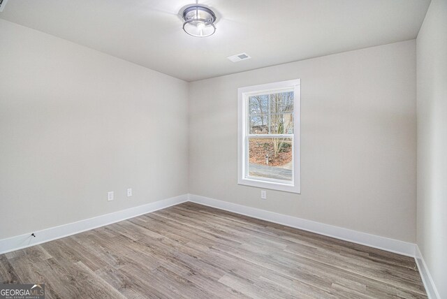 empty room with ceiling fan and dark wood-type flooring