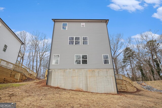 back of house with a yard and a wooden deck