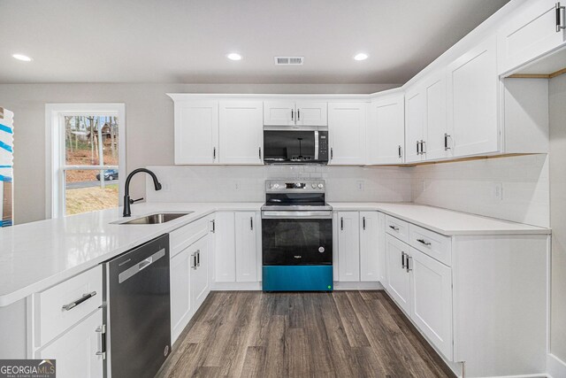 kitchen with stainless steel dishwasher, ceiling fan, sink, white cabinetry, and hanging light fixtures