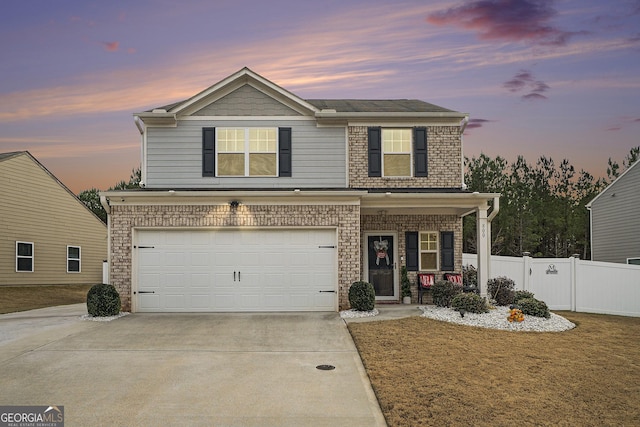 front facade with covered porch and a garage