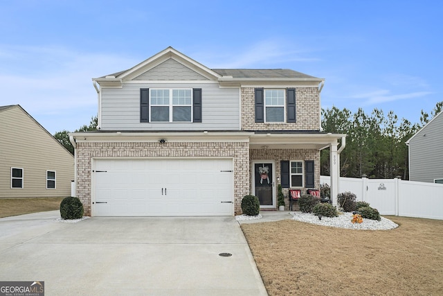 front facade featuring covered porch and a garage