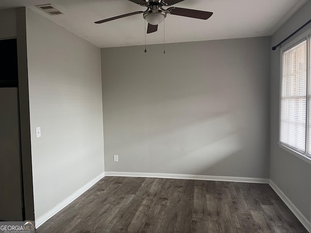 spare room featuring ceiling fan and dark hardwood / wood-style flooring