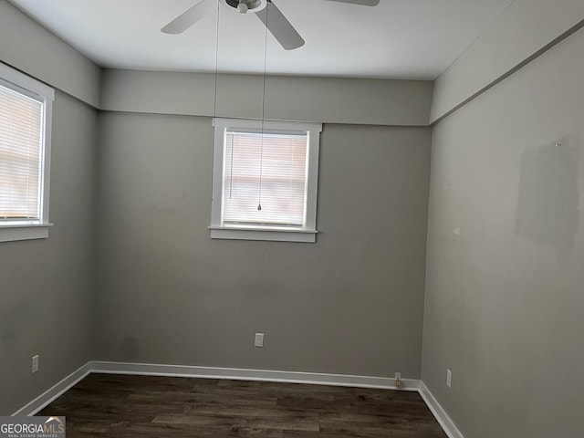 unfurnished room with ceiling fan and dark hardwood / wood-style flooring