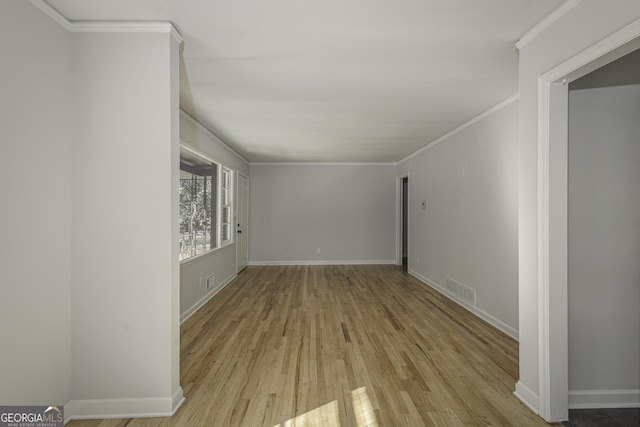 interior space featuring crown molding and light hardwood / wood-style flooring