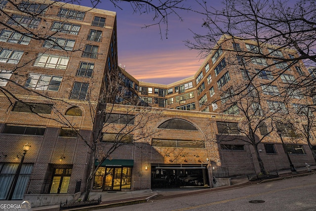 view of outdoor building at dusk