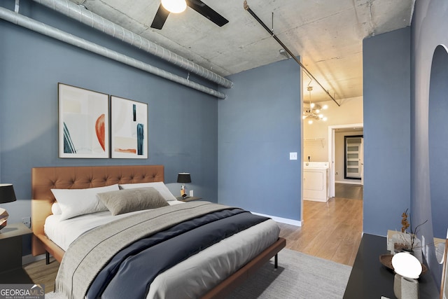 bedroom with ceiling fan, washer / clothes dryer, and light wood-style floors