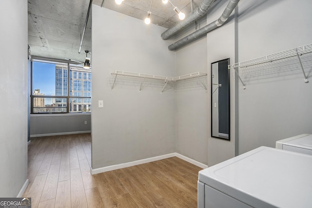 clothes washing area featuring washer and clothes dryer and hardwood / wood-style flooring