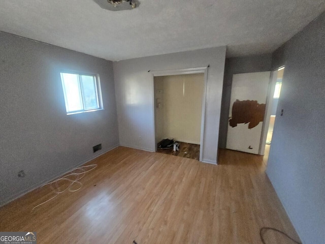 empty room with wood-type flooring