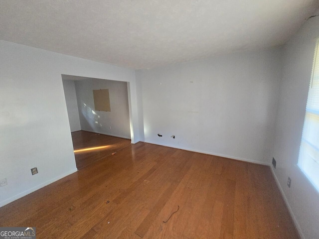 unfurnished room with hardwood / wood-style floors