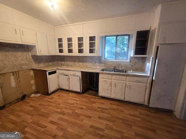 kitchen featuring white cabinets, sink, and light hardwood / wood-style flooring